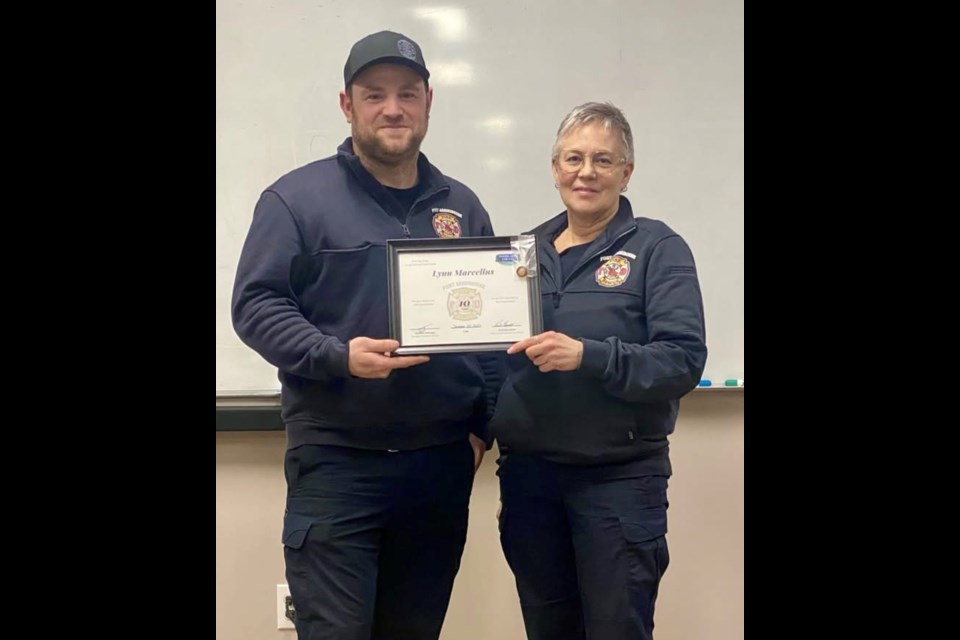 Chief Devin Williams presents Lynn Marcellus with her 10 year Service Award. Photo Supplied.