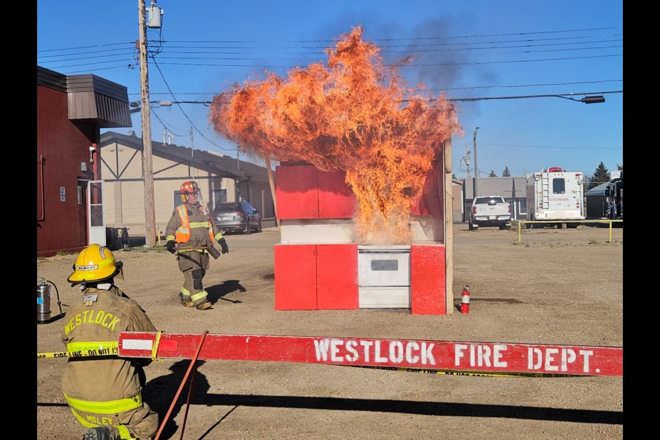 Firefighters keep close watch on a kitchen grease fire during a demonstration at the Fire Prevention Week open house at the Westlock Fire Hall on Saturday.  