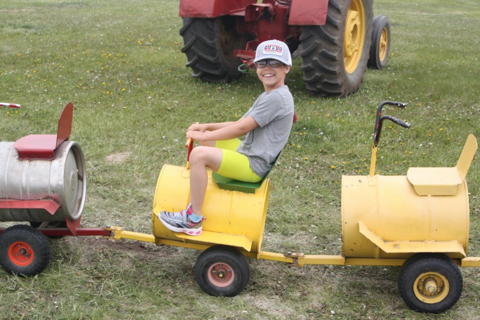 Daisy Pettifer looks cheerful as she rides the kids’ barrel train around the Westlock Agricultural Society grounds on June 2.