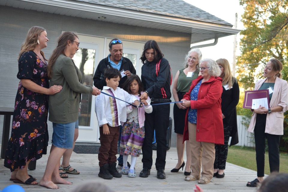 Amber's family cuts the ceremonial ribbon during Amber's Hope grand opening on Sept. 9.