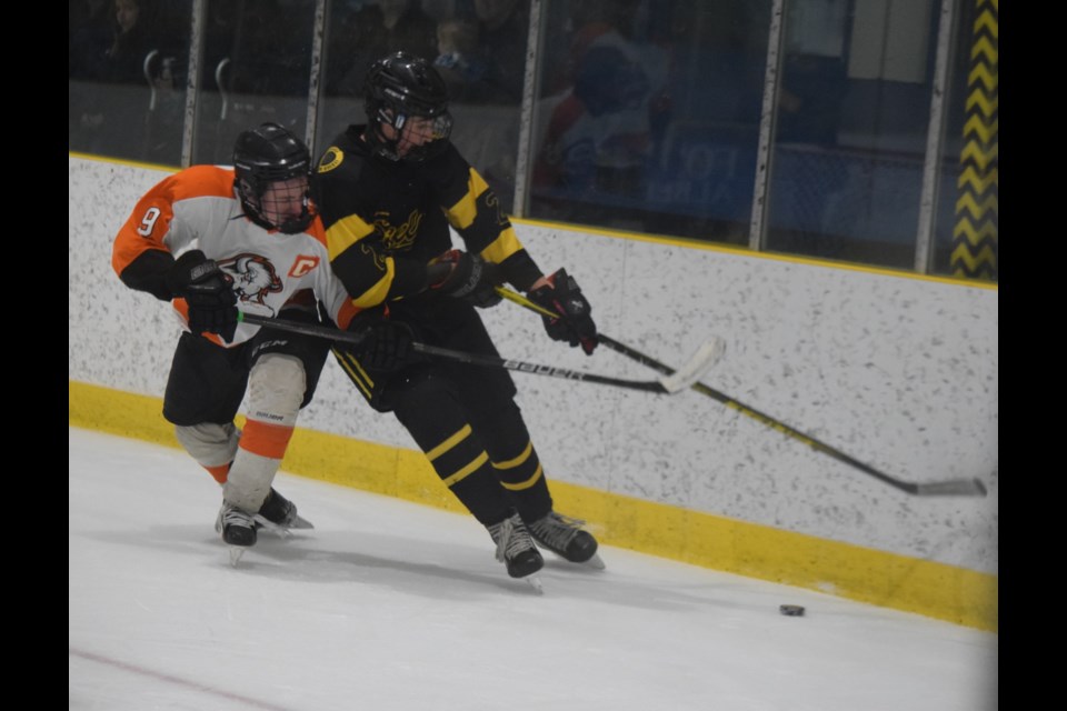 Barrhead Steeler Ashton Luciuk fights for the puck with Wainwright’s captain Jace Loheim behind the oppositions net.