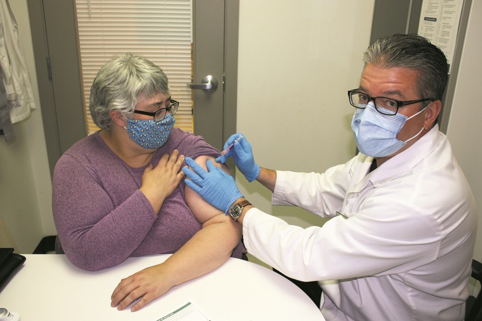 Flu shots are now available through Alberta Health Services and at pharmacies across the province as of Oct. 19. More than 1.4 million received the shot last year, but 8,500
still contracted the virus and 39 died as a result. This year, with COVID-19 presenting similar
respiratory symptoms as the flu, chief medical officer of health Dr. Deena Hinshaw has said
the more COVID-19 tests performed due to influenza symptoms can be avoided, the stronger the health system will be to support COVID-19 patients. Pictured, intrepid Athabasca Advocate
reporter Heather Stocking took a shot for the team at the Tipton’s Your Independent Grocer pharmacy Oct. 21 from pharmacist Rob Bownes. It was reportedly quick and painless. It is advised that anyone wanting a flu shot should call ahead to ensure they are in stock.

Chris Zwick/AA