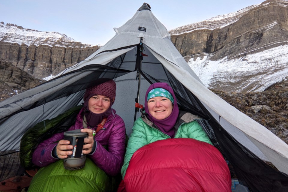 Lauren Reed and Bethany Hughes are avid outdoor enthusiasts who started hiking, biking, and paddling from Patagonia with the goal of finishing their pilgrimage in Tuktoyaktuk, NWT, the most northerly part of North America. Here they keep warm camping at the highest point 2,590 m (8,500 ft) of the Great Divide Trail.