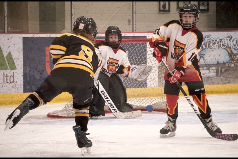 Benjamin Stewart, #9, lays a shot on net as Jack Spearin hopes to get a piece of the puck.                                