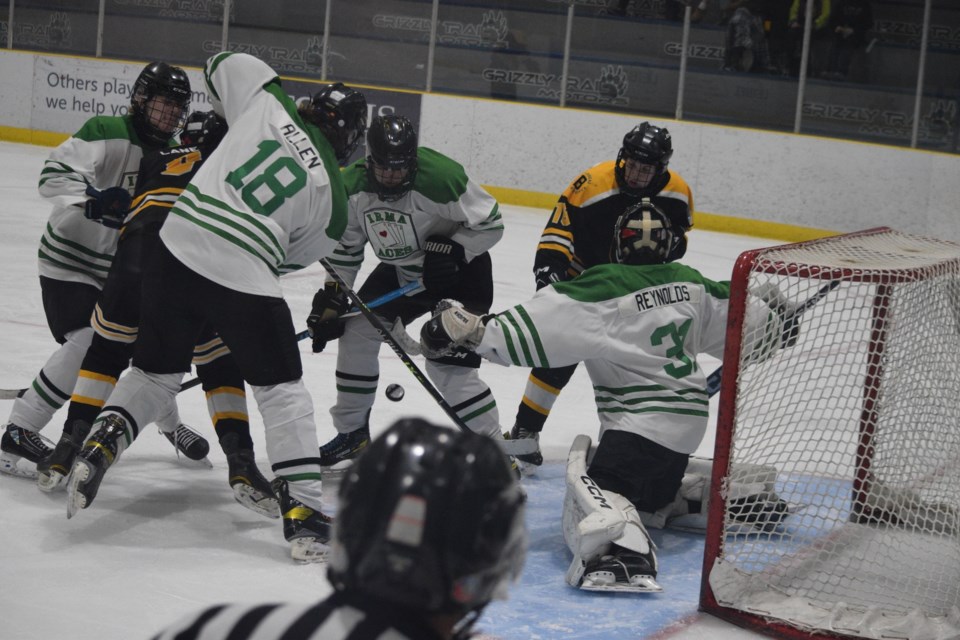 Barrhead Renegades Caden Lane (left) and Layne Young look for a loose puck in front of the Mannville/Irma Aces net.