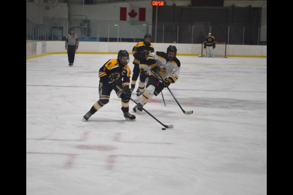 Barrhead forward and Renegades captain Cade Lane drives to the net, skating through the faceoff circle.