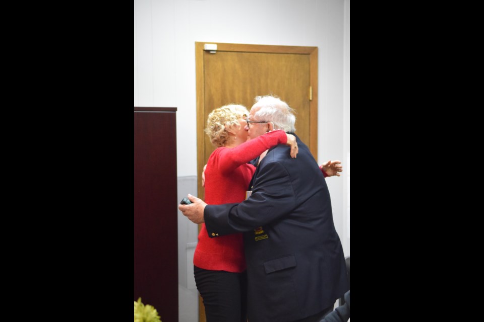 Cindy Jackson hugs her father after he received the King Charles III Coronation Medal.