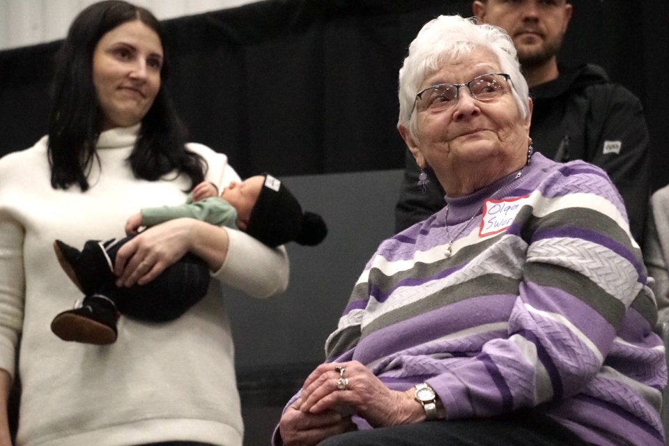 Olga Sworin was named the 2025 Pioneer Woman of the Year after being nominated by her daughter for her decades of dedication and grit, having raised a family in a house with no running water or electricity until 1979. Her granddaughter Danika Baldwin and fifth great-grandson Colter Baldwin, two fruits of her life-long labour, stand behind Olga on stage.                                