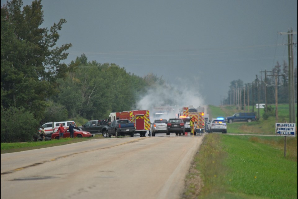 Emergency crews tend to the scene of a multi-vehicle collision on Highway 769 — the road to Neerlandia — on Friday afternoon.