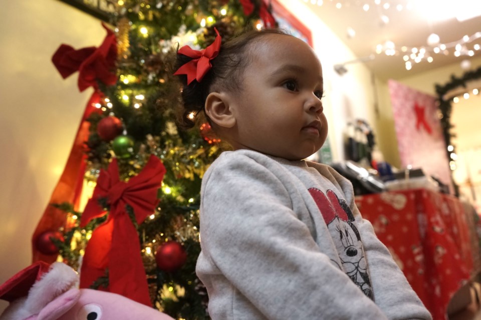 Two-year-old Kehlani Brown proved to be a bit camera shy when posing for a photo in front of one of the centre’s Christmas trees.                             