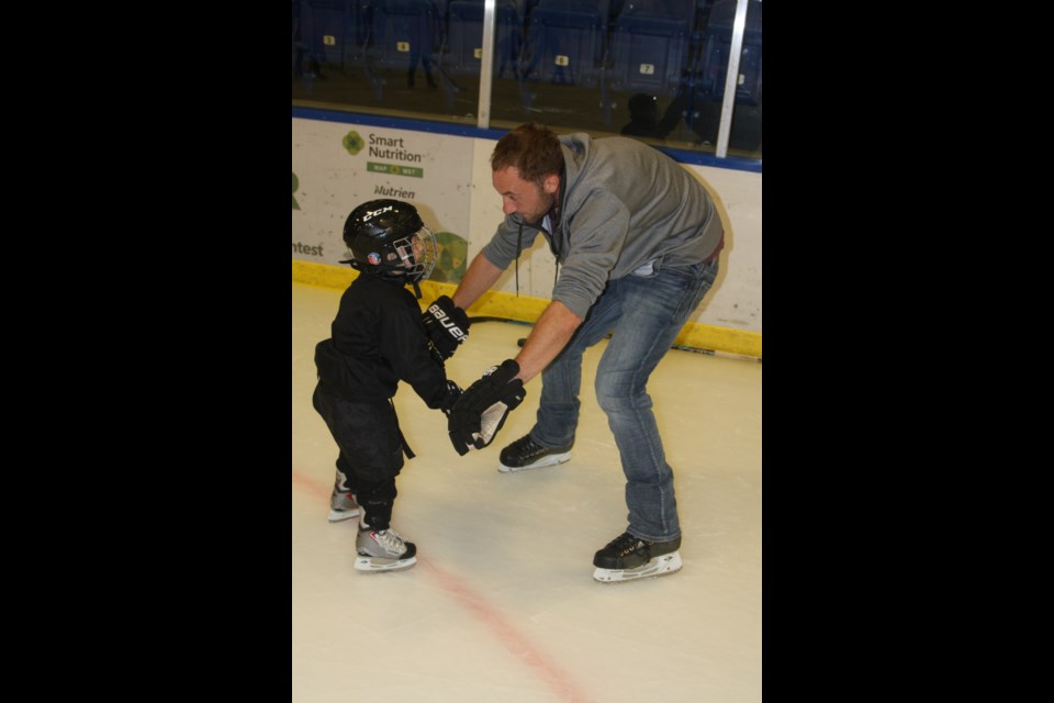 Clayton Miller, right, assists his son Ryan with skating around the ice during the 'I Love Hockey' event at the Westlock Rotary Spirit Centre Oct. 1.