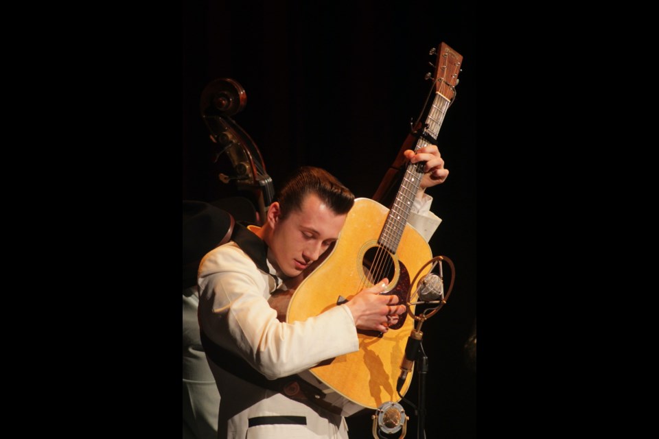 Jake Vaadeland lifts his guitar up to his face while performing for a nearly full house at the Westlock Cultural Arts Theatre on Nov. 3. Vaadeland and the Sturgeon River Boys were the opening act in the Westlock Cultural Arts Society's 2023-2024 concert series.