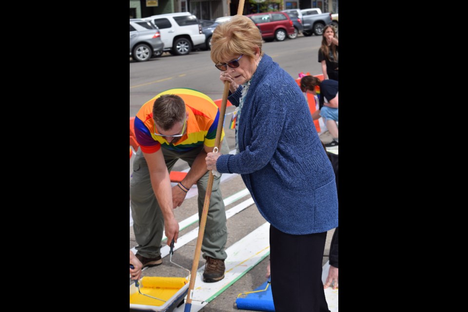 Jeanne Bozak, the first sponsor of Barrhead's Pride crosswalk paints one of the stripes.