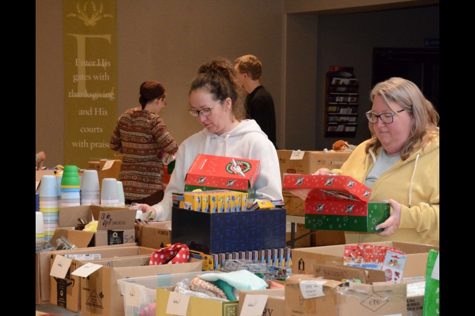 Jen Bizuns (l) and Tarra Mackinnon during Barrhead Alliance Church's Operation Christmas Child packing party.