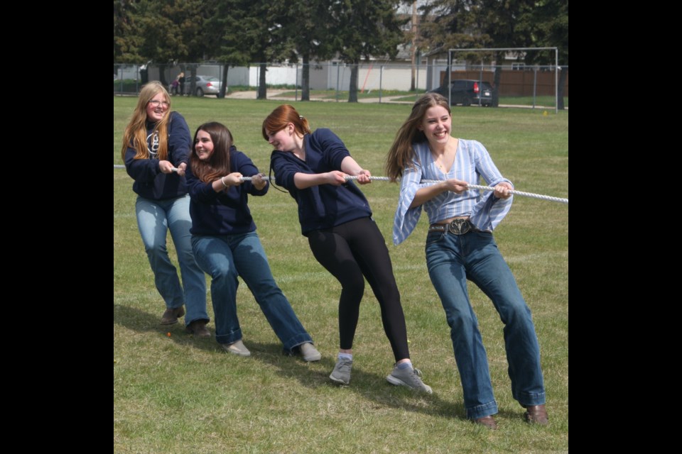 Avery Lutgen, Paige Jolliffe, Taeva McKay and Ariel Noble take part in a tug-of-war against another group of girls during an outdoor carnival hosted at R.F. Staples School in Westlock on May 21.