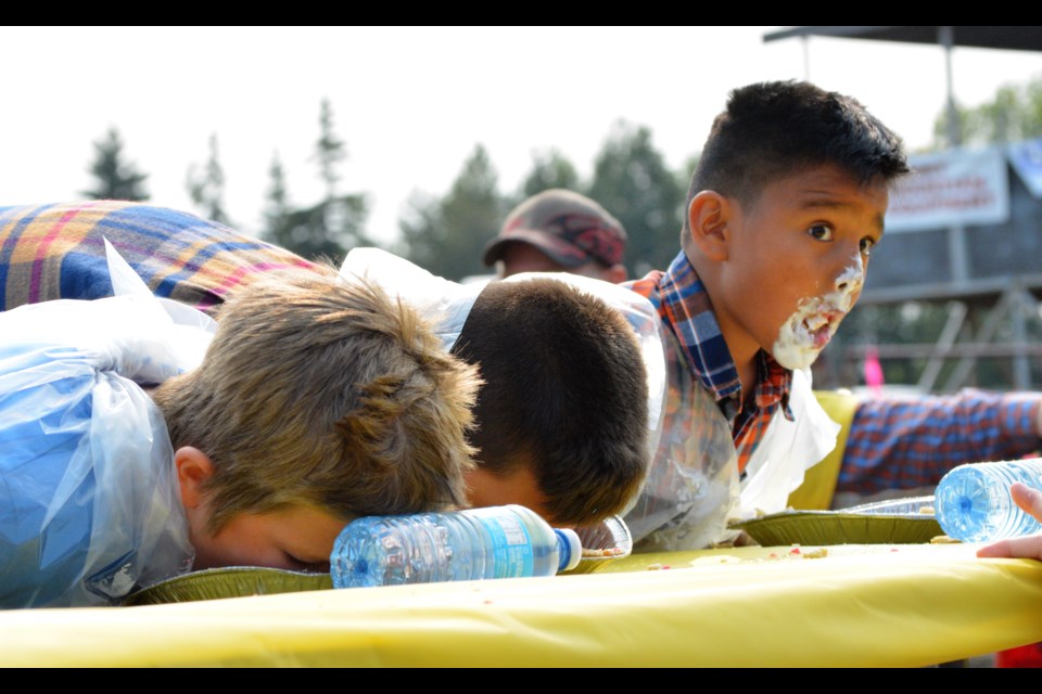 Iker Lopez looks up for a moment while competing in the inaugural pie eating contest Aug. 20 — the eventual winner was 17-year-old Marc Duriu from Thorhild.