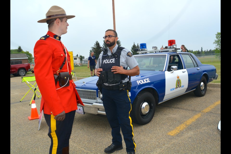 Westlock RCMP Const. Teo Verdicchio, left, speaks with Const. Jalal Azguagh of 'K' Division.