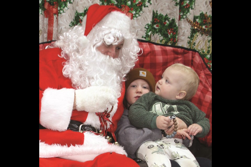 One-year-old Hudson Hopp isn’t too sure what to make of Santa during the youth Christmas Market and Craft Fair hosted by Community Futures Tawatinaw Region at the Westlock Memorial Hall on Nov. 16. Sitting with him is his three-and-a-half-year-old brother Hunter Hopp, who told Santa he wants a digger with a wagon for Christmas. The two boys came with their parents Jenessa and Chad Hopp of Westlock. 