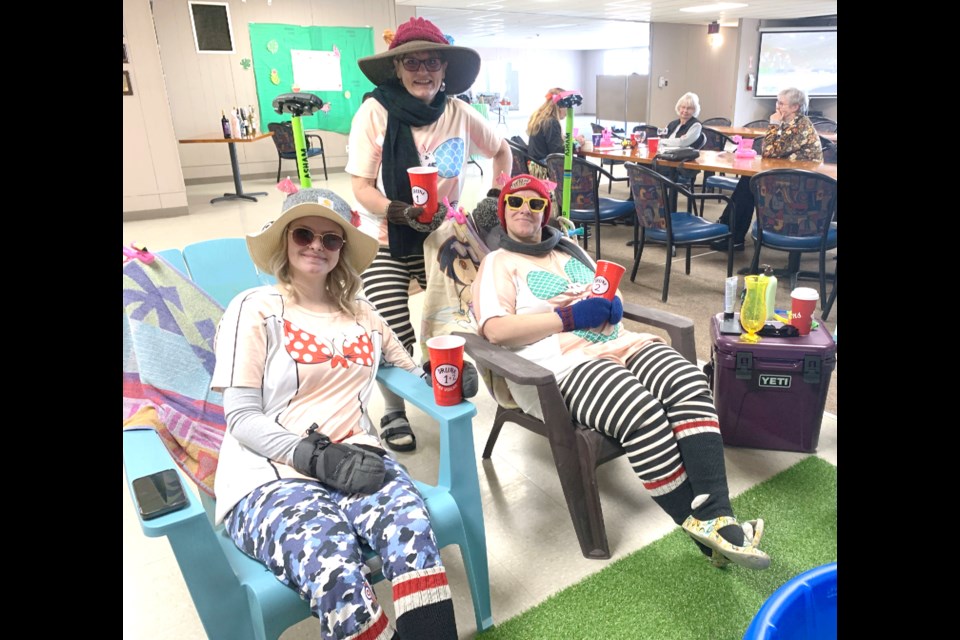 The theme of the Ladies Bonspiel in Westlock on Feb. 22 was Beach Party. Shown here are, front from left, Annette Boissonnault and Sue Starr. Standing is Danielle Andrashewski. 