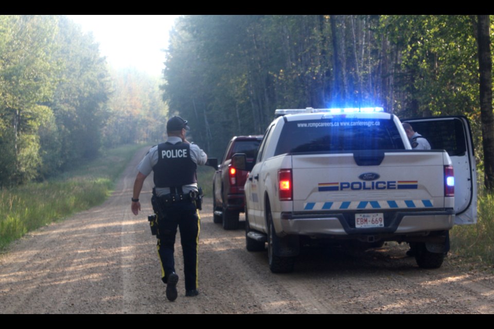 On Sunday morning, Westlock RCMP officers sit on a remote gravel road about 34 kilometres north of Westlock while they investigate an incident Saturday evening.  