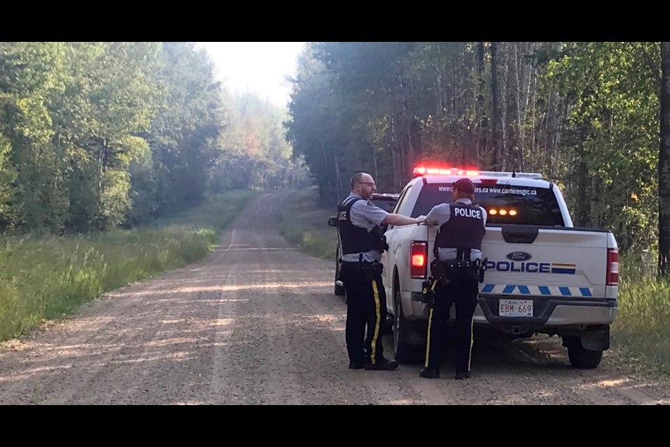 Westlock RCMP officers blocked traffic on the gravel road near the area the woman was found in September 2024. 