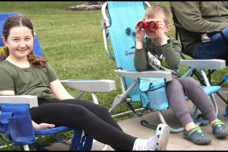 Vaugh Spargo of Busby uses his binoculars to watch the parade on Aug. 16 during the 108th Annual Westlock & District Agricultural Fair. With him are his sister Paige Spargo (left) and his parents Delanna and Regan Spargo (not shown).