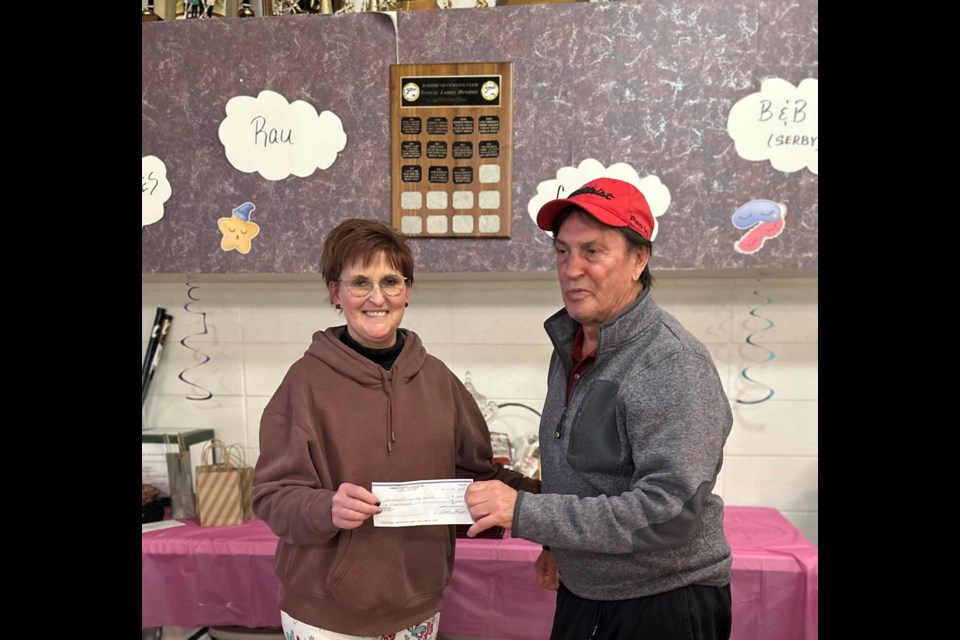 Dale Gummow presenting the Curling Club Manager, Krista Measures with a donation of $1000 in his late wife’s memory, Loreen Gummow. Loreen was a very avid curler for many years, and Dale has been honoring his late wife with a donation for the past 3 years. Photo supplied. 