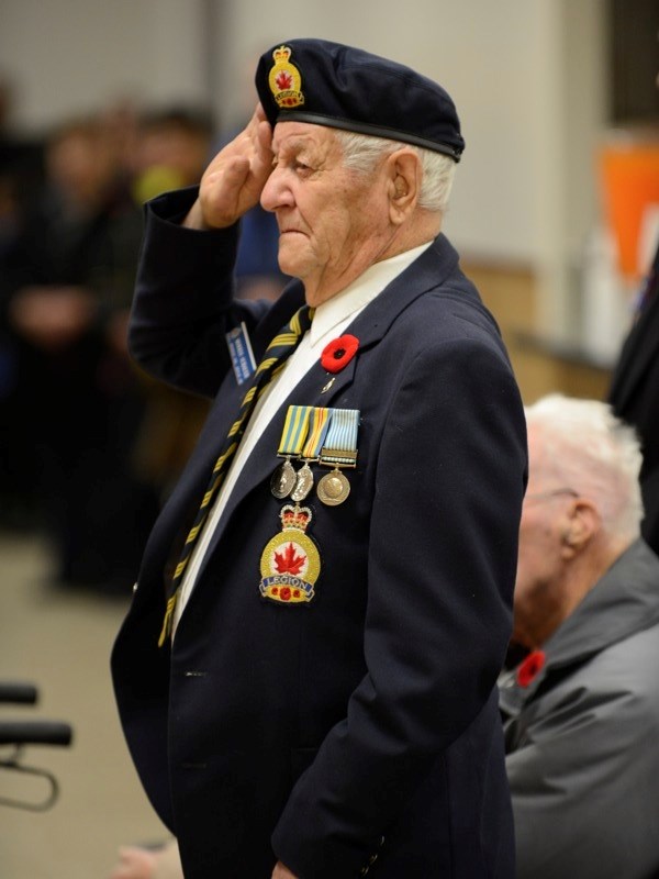 Veteran Morris Schauer stands and salutes as the Last Post is played during the Boyle Remembrance Day Ceremony Nov. 11, 2013, at the Boyle Community Centre.