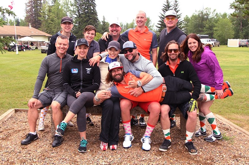 Team Sweeting, including curlers Val Sweeting and Dana Ferguson, get ready for their day on the green. Bryan Mudryk and curler Russ Howard auction off one of Howard old team