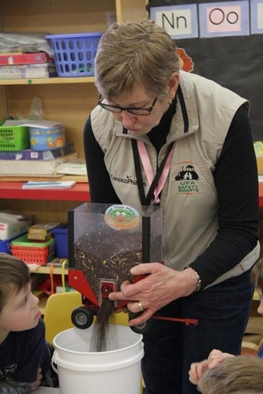 Ennis demonstrates the dangers of playing in a pile of grain for the Grade 1 and kindergarten students at Dunstable School on Feb. 23.