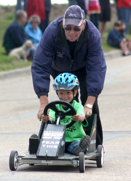 Derby vehicle inspector Vern Koesling gives Brayden Scarlett and his cart a helping hand.