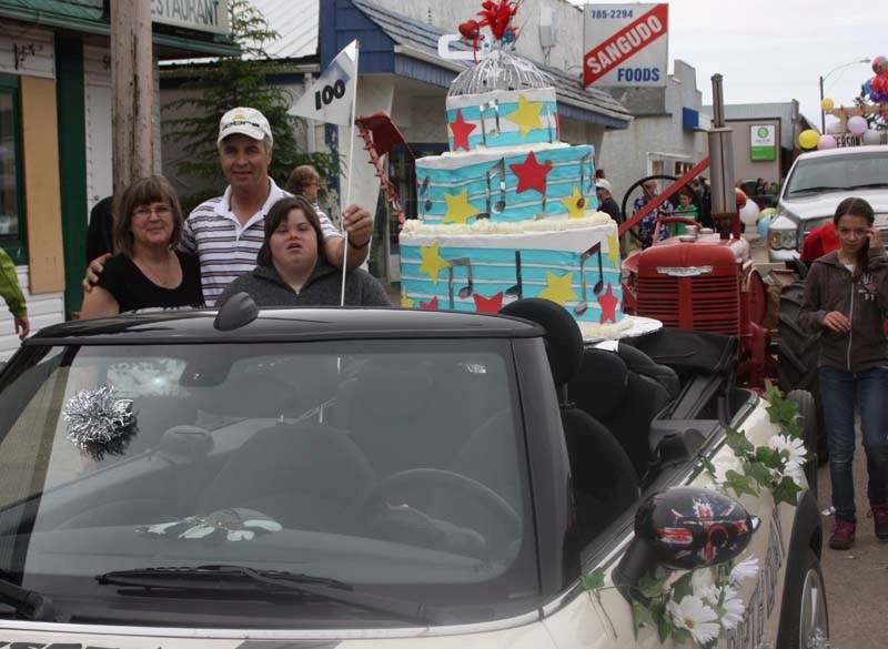 Family occasion: Dennis Roth, wife Dianne and daughter Kristen came from Slave Lake to celebrate Sangudo&#8217;s 100th homecoming. They decorated their car with a giant