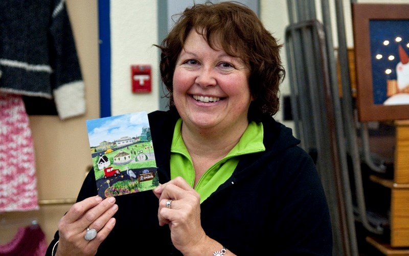 Local artist Sally George holds one of the Barrhead post cards she had available at the Festival of Trees Christmas Market, which took place over the weekend. The picture on