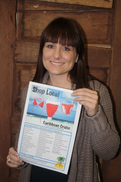 We need your support: Cheryle Morris with a poster promoting the Chamber of Commerce &#8216;s shop local campaign.