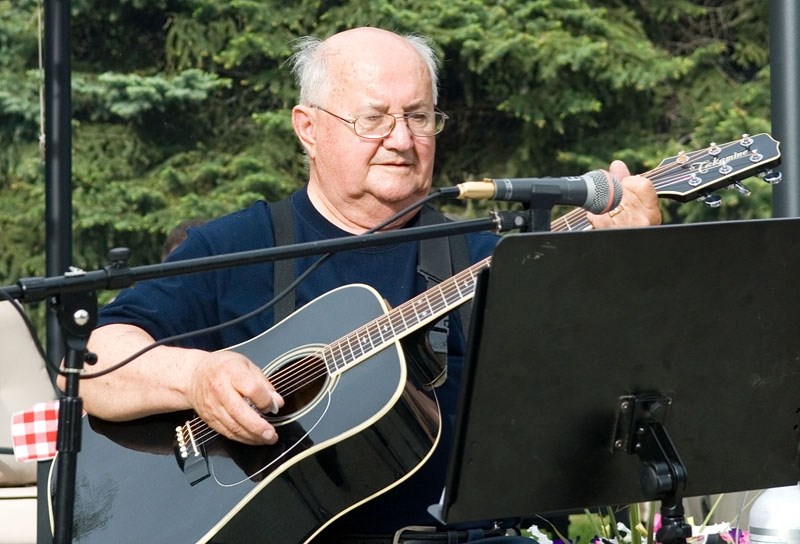 Joe MacIsaac plays guitar for Hillcrest residents during the campfire sing-along.