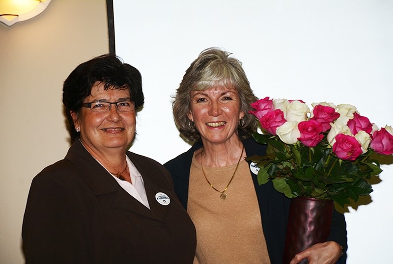 During a private function at the Westlock Inn on election night, Maureen Kubinec accepts a bouquet of flowers from Geri Savage, her chief financial officer for her campaign.