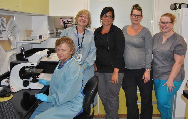 The Barrhead Healthcare Centre laboratory staff show off one of the new microscopes the hospital bought through the Tree of Hope campaign. From left: Judy Gibbard, MLT, Donna 