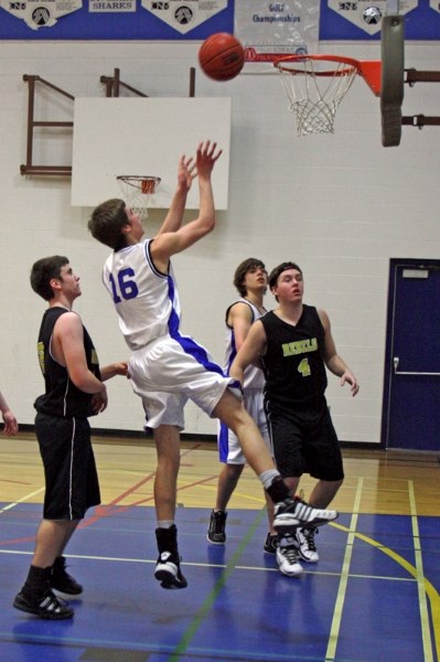 The St. Mary Sharks&#8217; Daniel Latimer jumps for a rebound during their Saturday afternoon 73-55 loss to Edson&#8217;s Holy Redeemer.