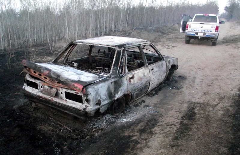 RCMP say this burned-out Toyota Camry was the cause of an 80-acre fire near Clyde that started last Sunday. The blaze, which firefighters say is under control, spread quickly 