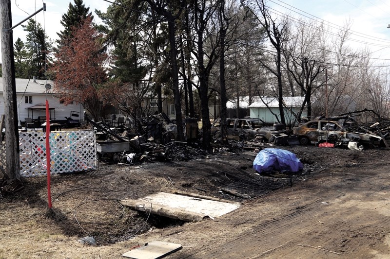 RCMP and the fire investigator continue to examine the aftermath of a garage fire early on April 29 to determine the cause of the blaze.