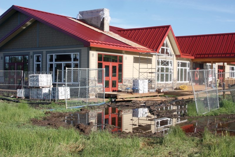 The new ski chalet at the Tawatinaw Valley Ski Hill is nearing completion, but is still facing delays and potential cost overruns as a result of water on the site. Pools of