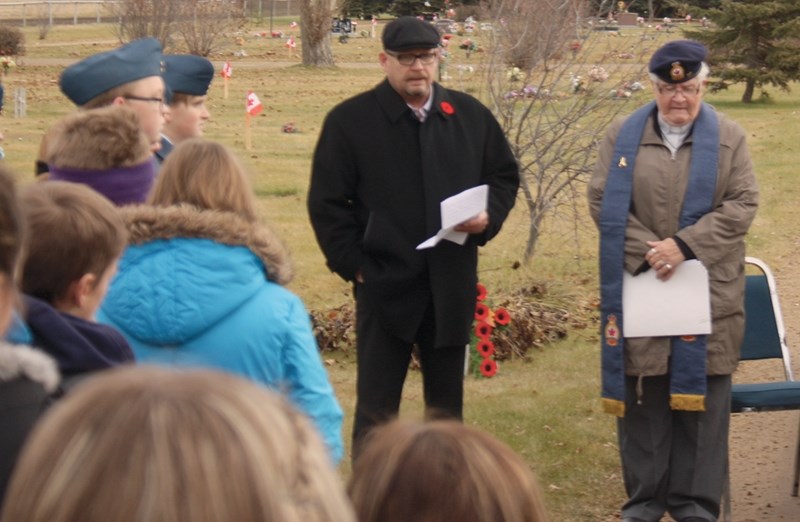 Westlock Mayor, Ralph Leriger addresses high school students at the Westlock Cemetery on Nov. 6 during the No Stone Left Alone ceremony. At right is Westlock Legion chaplain