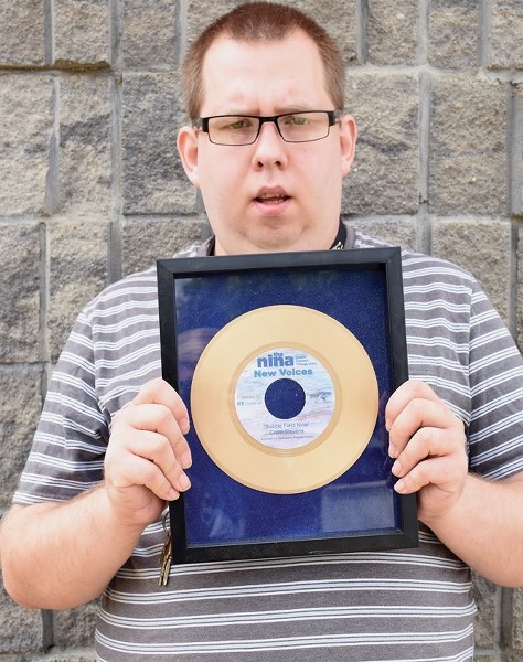 Collin Stevens poses with the Nina Haggerty Centre for the Arts’ Golden Record award for his song Bubble Field Nine.