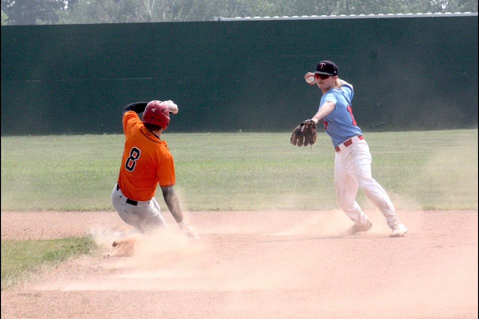 Parkland Twins player Ryan Poeter prepares to throw the ball to stop a sliding Chase Visser of the Barrhead Orioles at second base on Sunday.