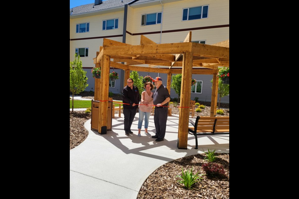 Hillcrest Lodge Evelyn Menzies Courtyard Opening on June 5, 2024. Ribbon cutting ceremony with Bill Lane, County of Barrhead Councillor, Roberta Hunt, Big Lakes Councillor, and Tyler Batdorf, CAO of BDSHA.