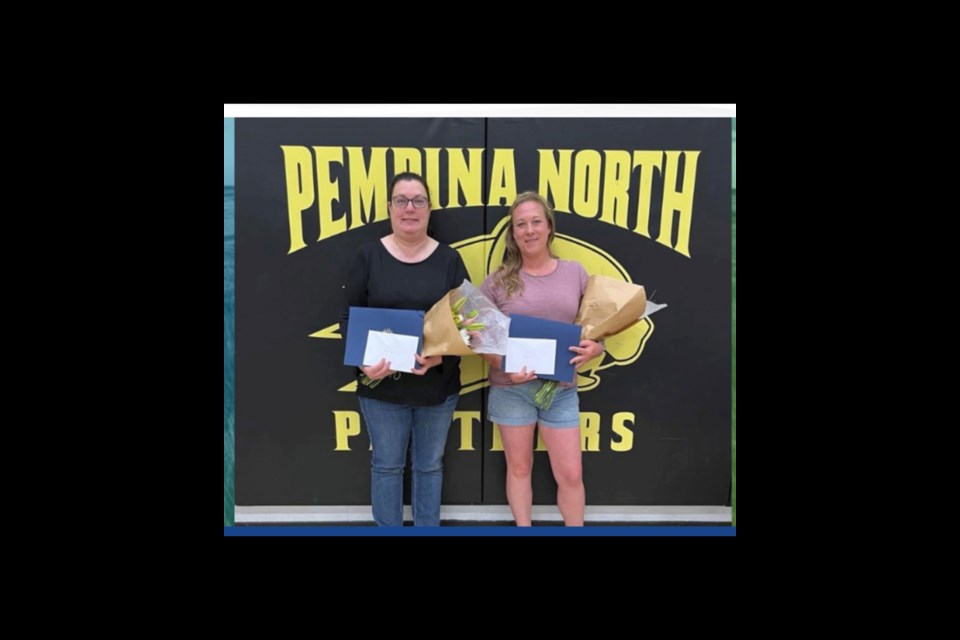 Charlene Dechaine and Andrea Gibson receive the Exemplary Parent Volunteer Award presented by Daryl Chattargoon, Principal, at the Pembina Hills School honored these two exceptionally giving volunteers at the assembly in Dapp on June 20.