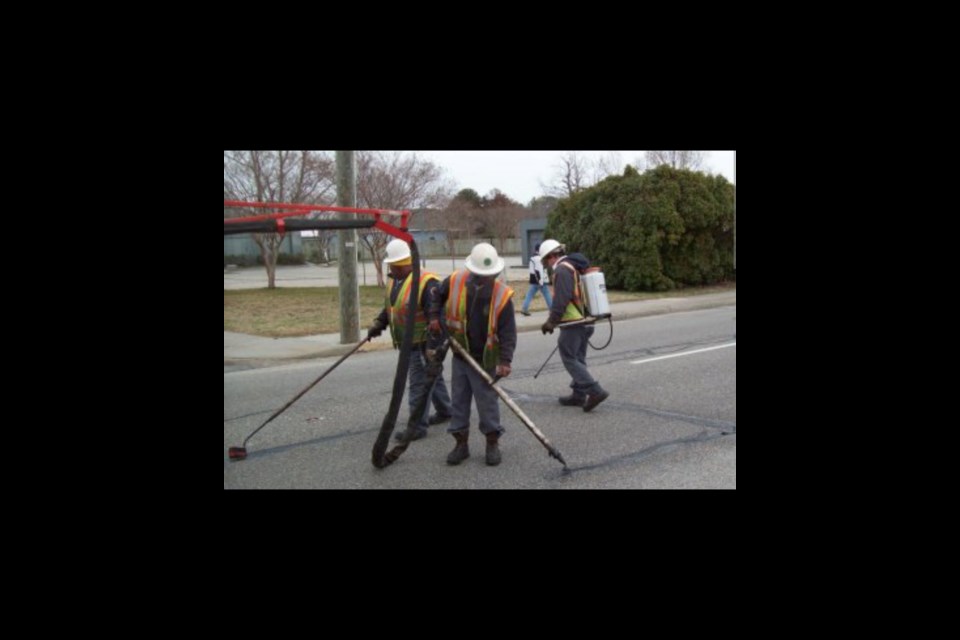 Road Maintenance workers complete crack sealing repairs