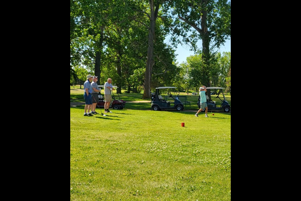 The Paddle River Golf Course hosted the Seniors Open July 11. Taking his shot is Wes Versailles, with Frank Gray, Michel Belanger and Arley Corbett watching.