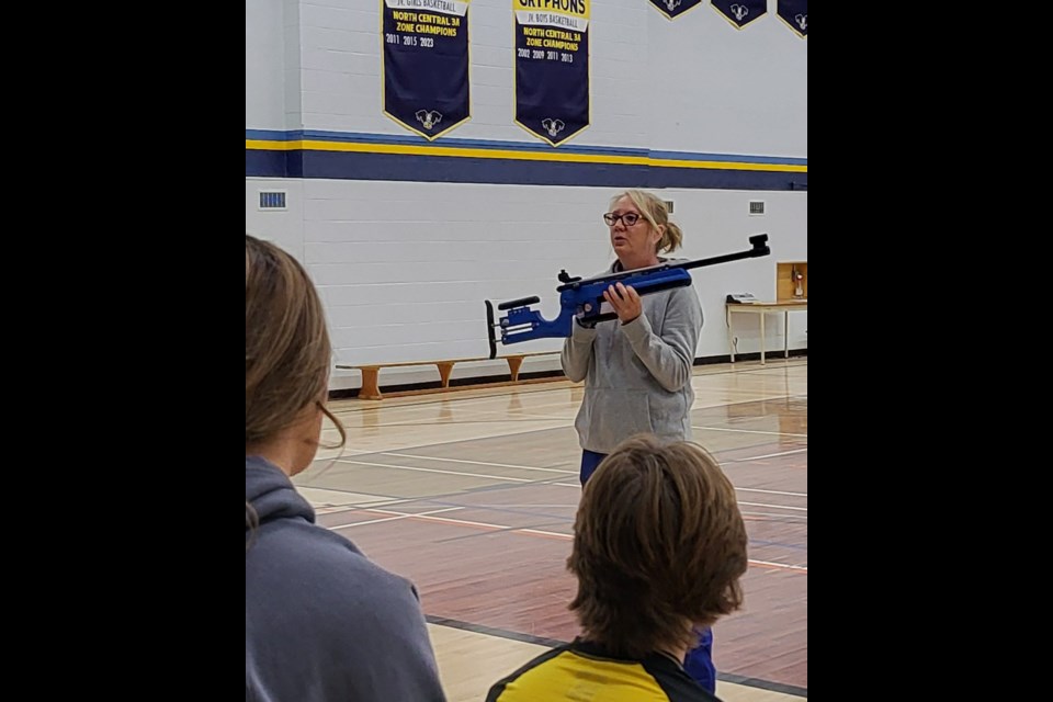 Ntala Quintilio, Outreach Coordinator for Biathlon Alberta, and biathlon athlete, from the Barrhead area, shows students at Barrhead High School how to use the shooting simulator.   