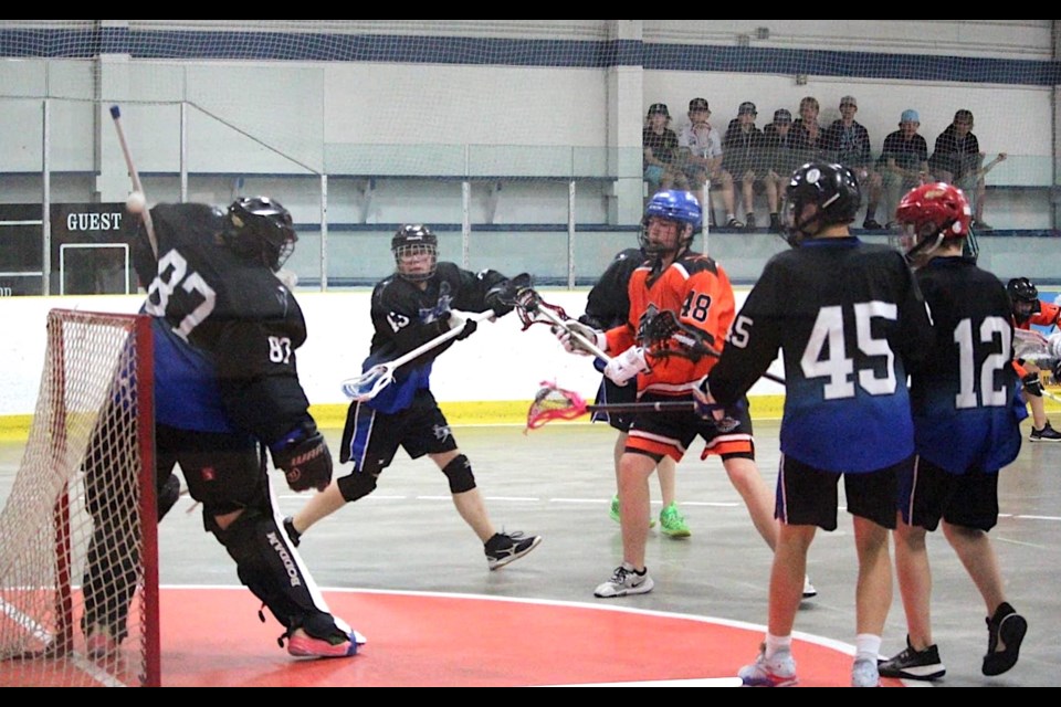 The Westlock Rock U17 lacrosse team are Greater Edmonton Lacrosse Council (GELC) league champions, after and exciting 5-4 overtime victory, against the Leduc Crush June 26. They will now represent the GELC at the provincial championships July 12-14 in Red Deer and Sylvan Lake. Westlock Rock goaltender Devlyn Finnegan, deflects the ball during the final, against the Leduc Crush, while teammantes L-R Dax Crossland (#43), Carter Stevens, Dyllan Marlo (#45) and Dayce Madson (#12) look on. Submitted photo .